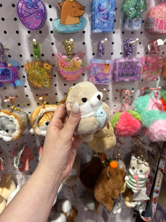 Otter with fish plushie