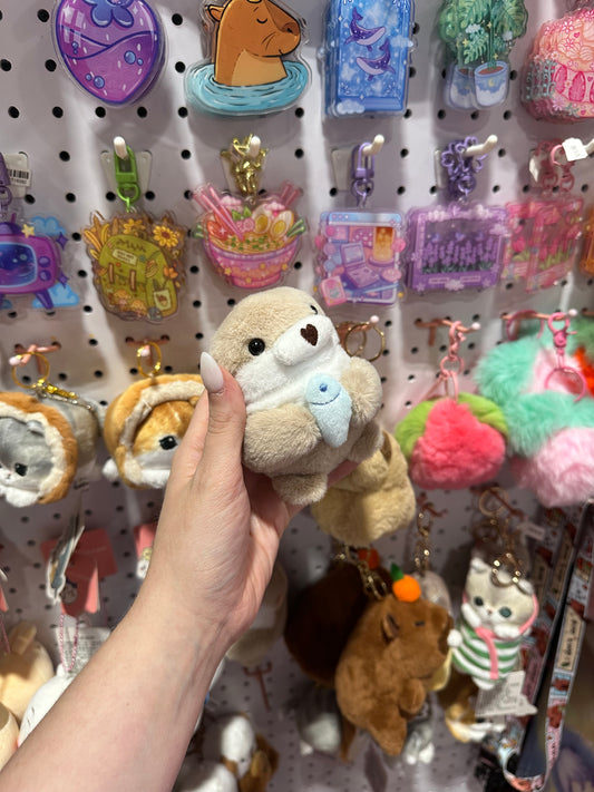Otter with fish plushie